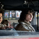 The kids of Ghostbusters: Afterlife sit in Ecto-1 from left to right: Mckenna Grace, Logan Kim, and Finn Wolfhard.